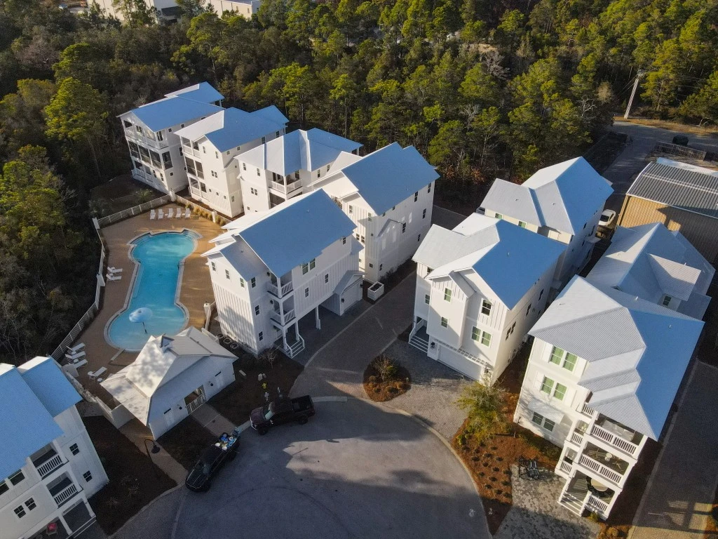 Aerial view of beach homes and the community pool at The Village at Grayton Beach