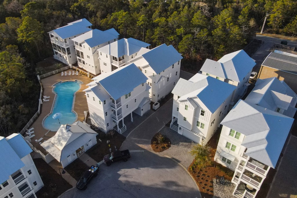 Aerial view of beach homes and the community pool at The Village at Grayton Beach